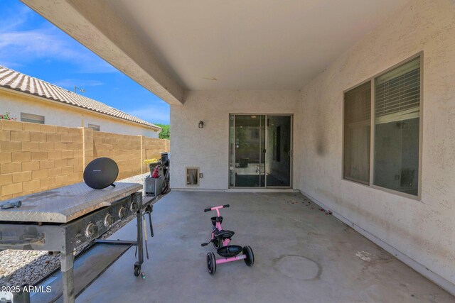 view of patio / terrace featuring fence