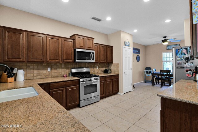 kitchen featuring decorative backsplash, ceiling fan, visible vents, appliances with stainless steel finishes, and a sink
