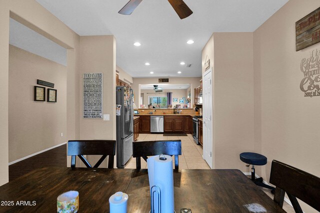 dining space with baseboards, a ceiling fan, and recessed lighting