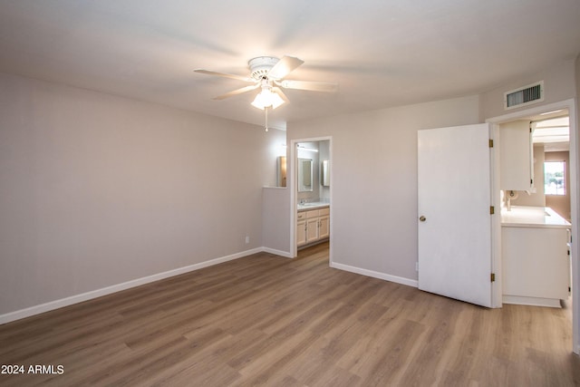 4502 E Carol Ave Unit 1, Mesa, AZ 85206 - unfurnished bedroom featuring baseboards, connected bathroom, light wood finished floors, ceiling fan, and visible vents