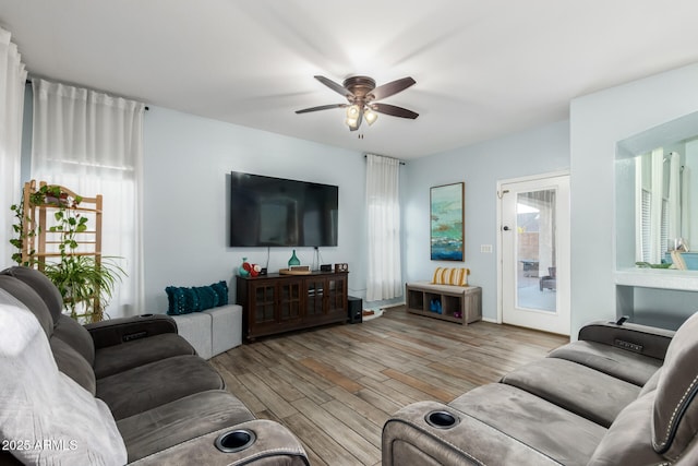 living area with ceiling fan and wood finished floors