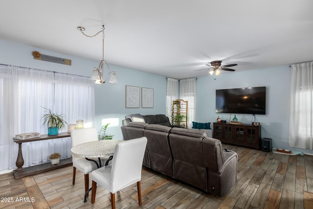 living area featuring wood finished floors and a ceiling fan