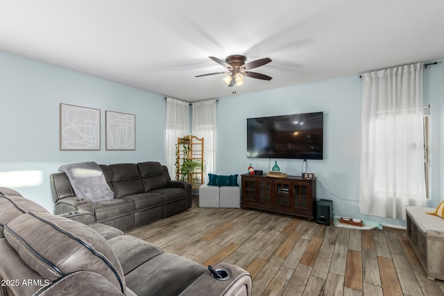 living room with a ceiling fan and wood finished floors