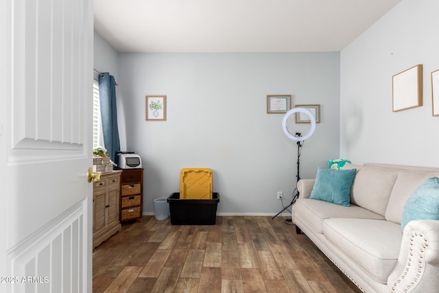 living area with baseboards and wood finished floors