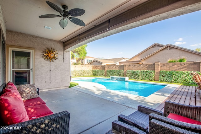 view of swimming pool with ceiling fan, a patio, a fenced backyard, and a fenced in pool