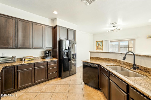 kitchen with visible vents, dark brown cabinets, light tile patterned floors, black appliances, and a sink