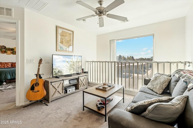 living room with visible vents, light colored carpet, and ceiling fan