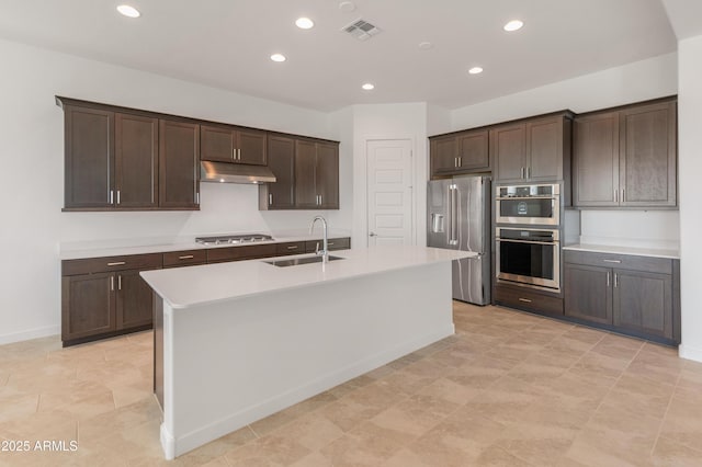 kitchen with stainless steel appliances, visible vents, a sink, dark brown cabinetry, and under cabinet range hood