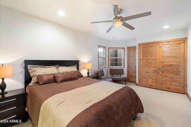 bedroom featuring ceiling fan and light carpet