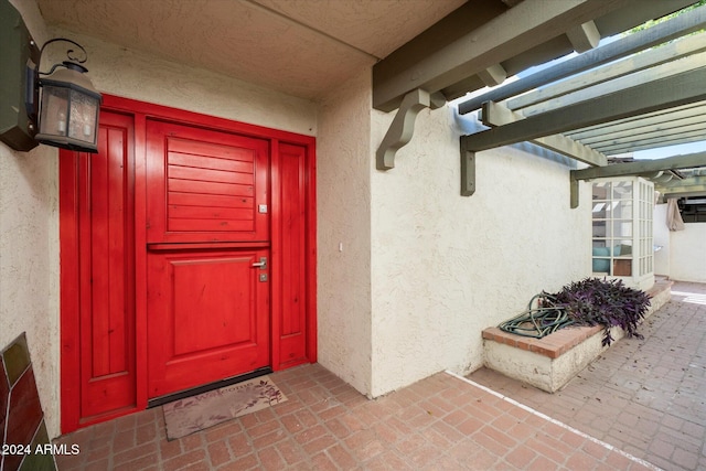 entrance to property featuring a pergola