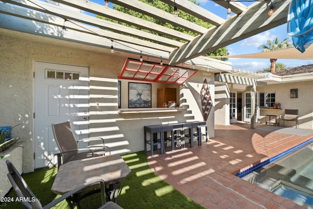 view of patio / terrace featuring a bar and a pergola