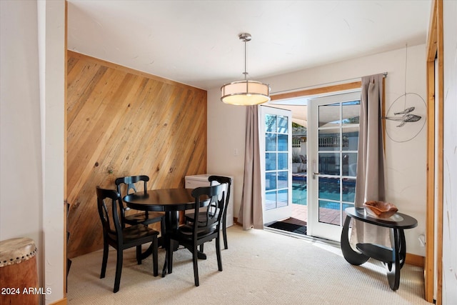 dining space with wood walls and plenty of natural light