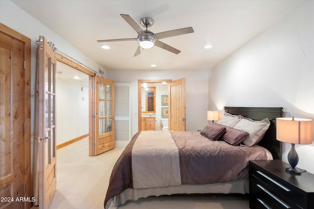 carpeted bedroom featuring ceiling fan, connected bathroom, and french doors