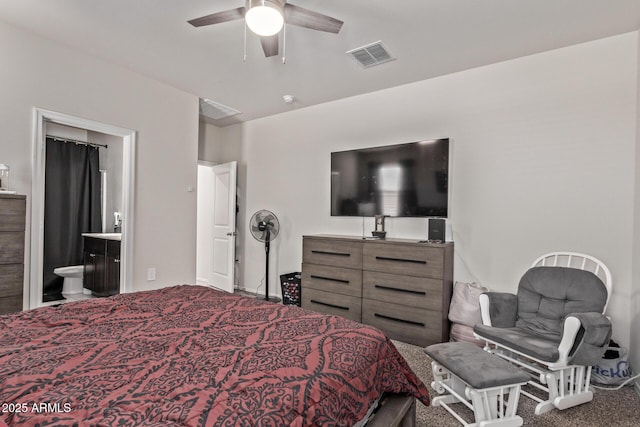 carpeted bedroom with connected bathroom and ceiling fan