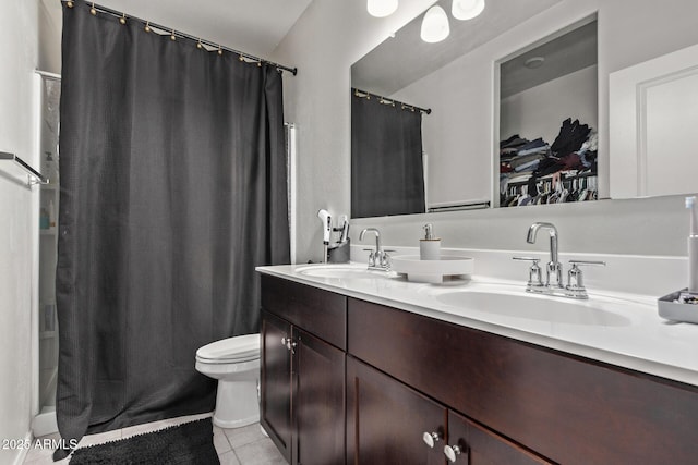 bathroom with vanity, toilet, curtained shower, and tile patterned flooring