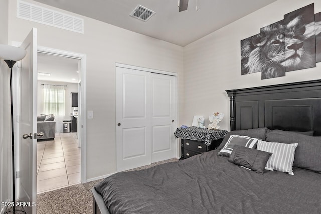 bedroom featuring carpet, ceiling fan, and a closet