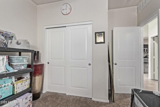 interior space with a closet and dark colored carpet