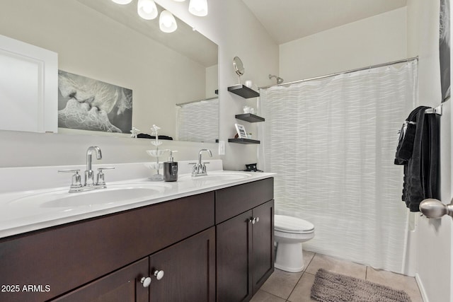 bathroom with tile patterned flooring, vanity, and toilet