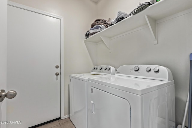 washroom with washer and dryer and light tile patterned floors