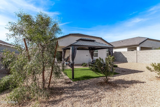 rear view of house featuring a gazebo