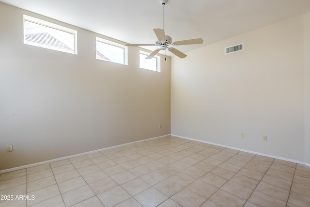 spare room with light tile patterned floors and ceiling fan