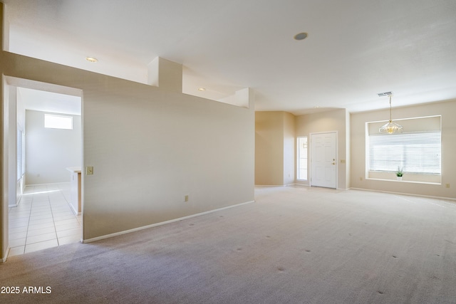 unfurnished room featuring light colored carpet