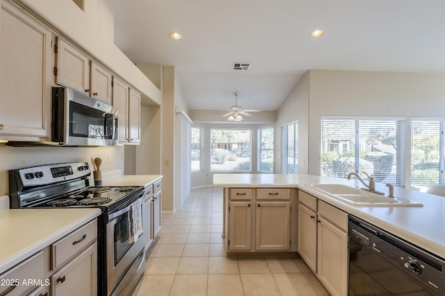 kitchen with sink, light tile patterned floors, stainless steel appliances, and a healthy amount of sunlight