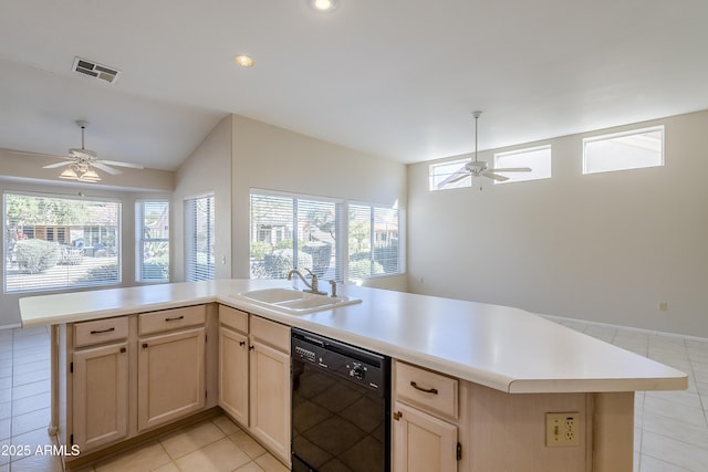 kitchen featuring dishwasher, light tile patterned floors, sink, ceiling fan, and a center island with sink