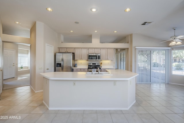 kitchen with stainless steel appliances, a wealth of natural light, a large island, and light tile patterned floors