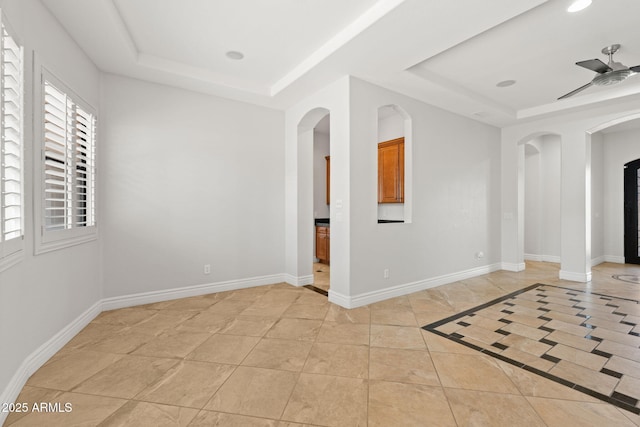 3215 E Constance Way, Phoenix, AZ 85042 - empty room featuring a tray ceiling, arched walkways, a ceiling fan, light tile patterned floors, and recessed lighting