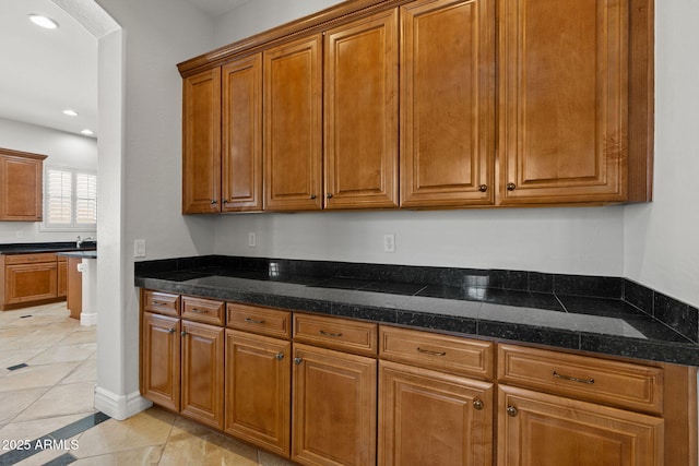 3215 E Constance Way, Phoenix, AZ 85042 - kitchen featuring brown cabinetry, light tile patterned floors, and recessed lighting