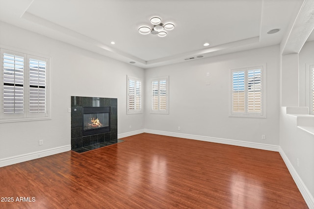 3215 E Constance Way, Phoenix, AZ 85042 - unfurnished living room featuring a raised ceiling, wood finished floors, healthy amount of natural light, and recessed lighting