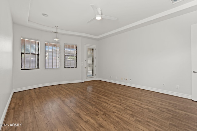 3215 E Constance Way, Phoenix, AZ 85042 - empty room with a raised ceiling, dark wood-type flooring, and ceiling fan