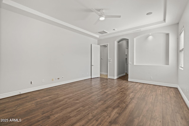 3215 E Constance Way, Phoenix, AZ 85042 - empty room with dark wood-style floors, ceiling fan, and arched walkways
