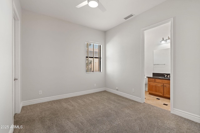 3215 E Constance Way, Phoenix, AZ 85042 - unfurnished bedroom with light colored carpet, ensuite bath, and a ceiling fan