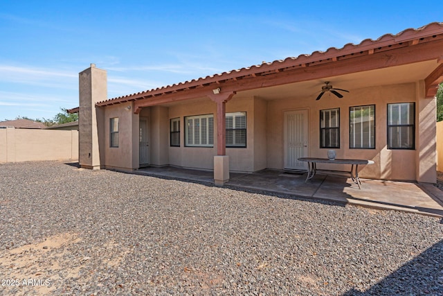 3215 E Constance Way, Phoenix, AZ 85042 - back of property with a ceiling fan, a patio area, stucco siding, and a chimney