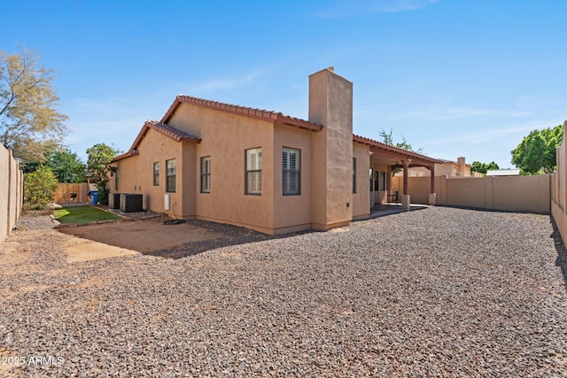 3215 E Constance Way, Phoenix, AZ 85042 - rear view of house with a chimney, a fenced backyard, a tile roof, and a patio