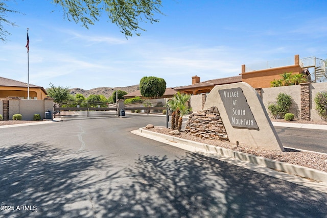 3215 E Constance Way, Phoenix, AZ 85042 - view of asphalt street featuring a gate, a gated entry, a mountain view, and curbs