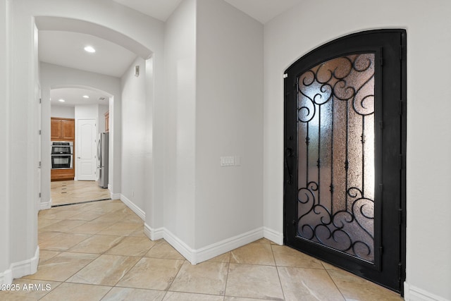 3215 E Constance Way, Phoenix, AZ 85042 - entrance foyer featuring light tile patterned flooring, arched walkways, and recessed lighting