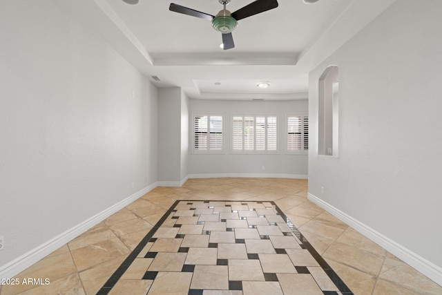 3215 E Constance Way, Phoenix, AZ 85042 - empty room with inlaid floor details, a tray ceiling, ceiling fan, and light tile patterned floors