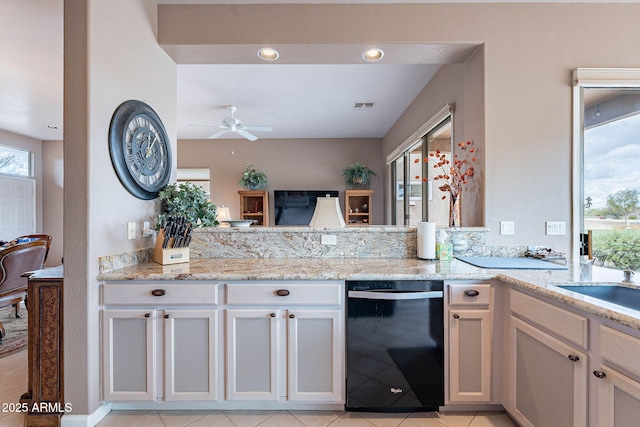 kitchen with light stone counters, visible vents, black dishwasher, and a ceiling fan