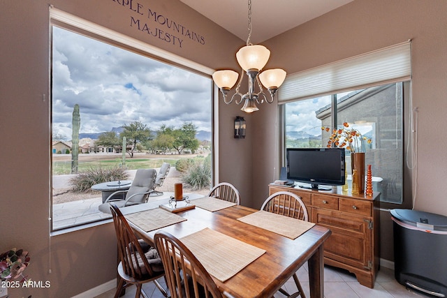 dining area with a notable chandelier and light tile patterned floors