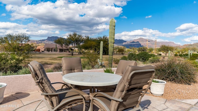 view of patio with a mountain view and outdoor dining area