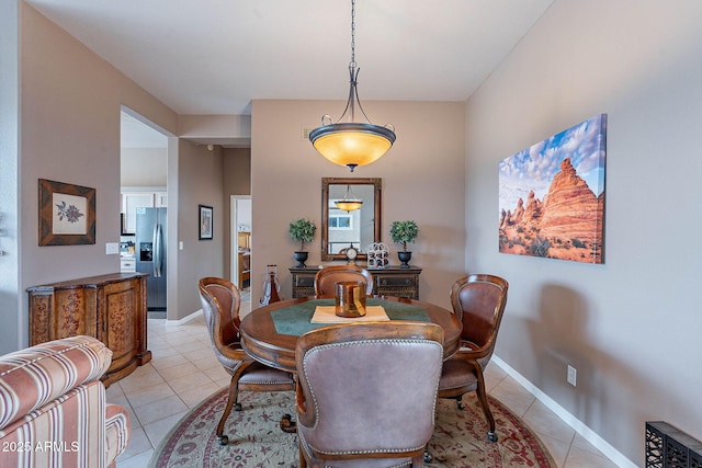 dining room with light tile patterned floors and baseboards