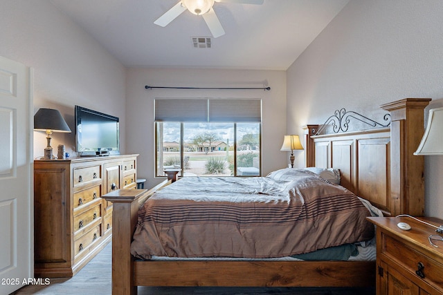 bedroom with visible vents, wood finished floors, and a ceiling fan