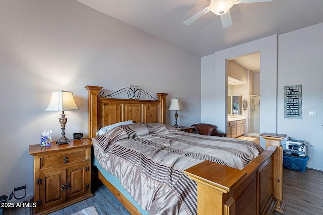 bedroom featuring ensuite bath, lofted ceiling, a ceiling fan, and wood finished floors