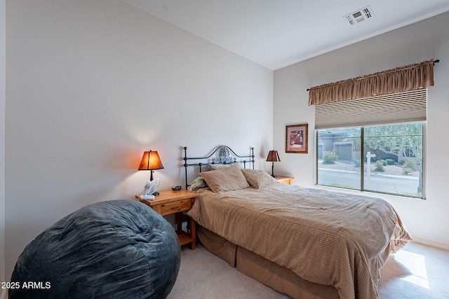 bedroom with visible vents and carpet flooring