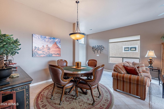 dining space with light tile patterned flooring and baseboards