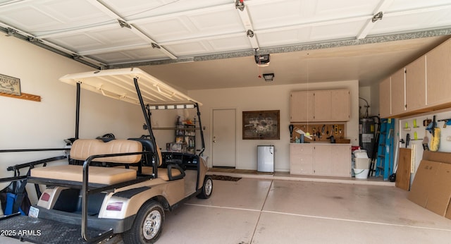 garage featuring a garage door opener and water heater