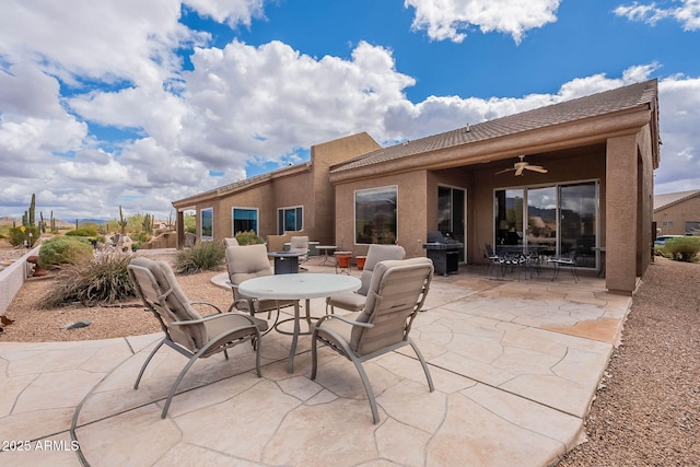 view of patio featuring outdoor dining area, grilling area, and ceiling fan